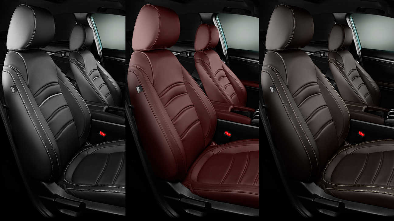 Zbliżenie na skórzaną tapicerkę Hondy Civic 5 w kolorach wiśniowym Bordeaux Red, czarnym Midnight Black i brązowym Dark Brown.