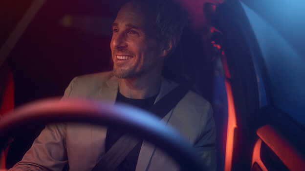 Close of a man sitting behind the wheel of the car. 