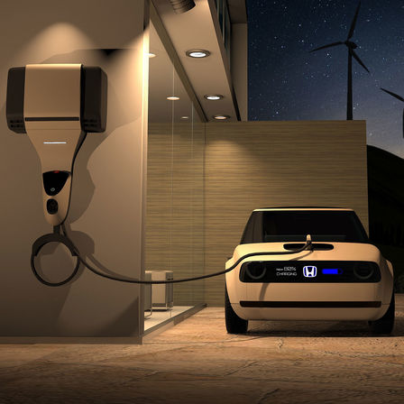 Widok Hondy Urban EV Concept z przodu podłączonej do stacji ładowania.