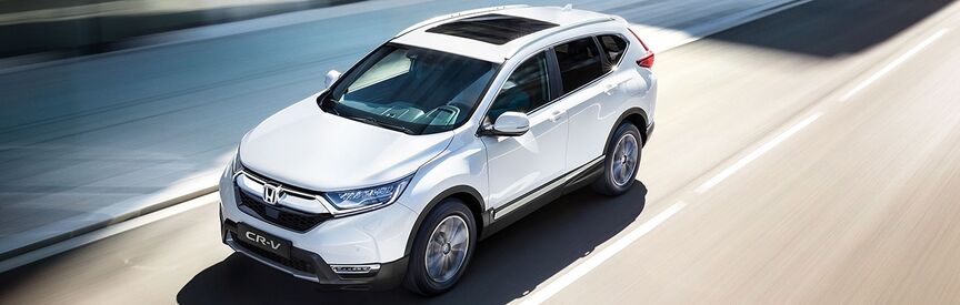 Biała Honda CR-V Hybrid SUV - widok z przodu.