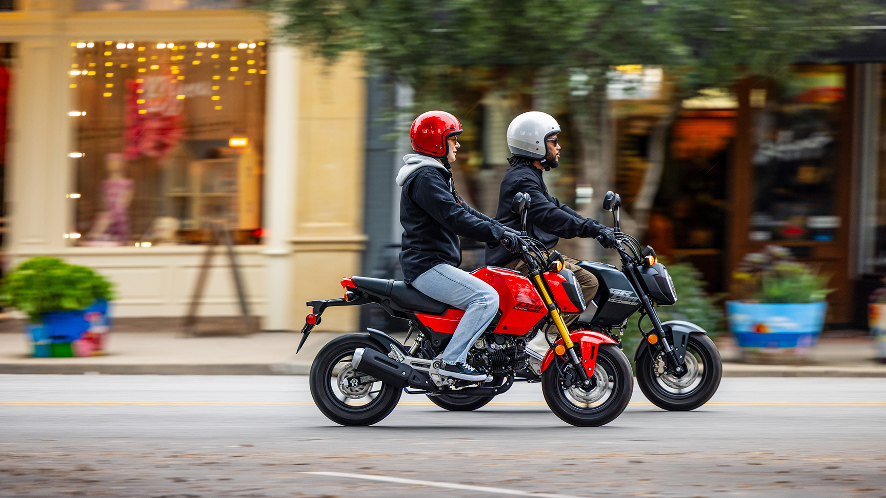MSX125 Grom w kolorze czarno-czerwonym, jadący przez miasto