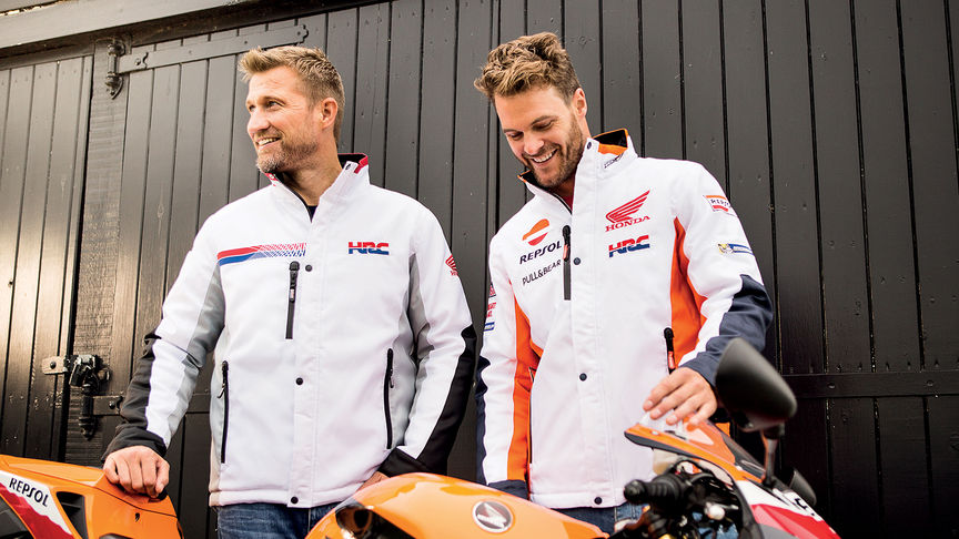 Dwóch uśmiechniętych mężczyzn w białych kurtkach wyścigowych Honda